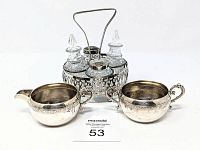 Front view of cruet caddy with sugar bowl and creamer set arranged with item number card in front.