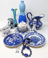 Front view of all vintage blue ceramics and glass items including Delft plates, vases, cups, and bracelet