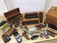 Wide view of all knives, stones, holders and boxes on tabletop