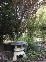 Overall grouping of topiary frame, concrete pagoda, and pots