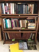 Three-shelf overview containing mixed hardcover and paperback history books