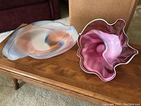 Two handblown glass bowls side by side on table