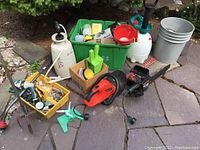 Overview of assorted garden tools and accessories, including sprayers, trimmers, funnels, fittings, and containers.