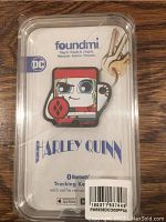 Photo of Foundmi brand Harley Quinn Bluetooth tracking keychain in original clear packaging showing character design and box text.
