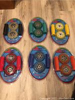 Photo showing six packages of Street Surfer scooter replacement wheels and handle grips in six different color combinations.