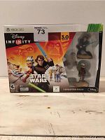 Front of the box showing Disney Infinity Star Wars 3.0 Edition with three character figurines included and Xbox 360 branding