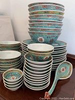 Stacks of dinner plates, soup bowls and rice bowls on sideboard