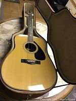 Full view of Yamaha FG-345B acoustic guitar in case showing body, neck, and headstock