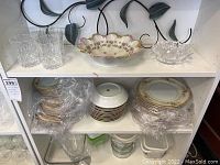 Shelf with decorative porcelain bowl, glass tumblers and crystal glass bowl