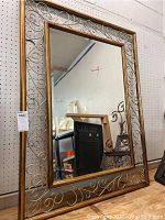 Full view of the large rectangular framed mirror showing overall size and reflective surface.