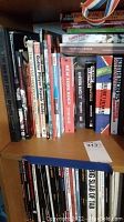 Shelf of music and guitar books showing variety of titles including The Red Hot Chili Peppers and Guitar Player Repair Guide