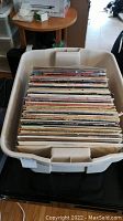 Stack of records in plastic tote viewed from top