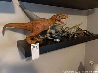 Overview of dinosaur figures and toy helicopter on shelf