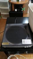 Full view of the turntable with dust cover in place, showing overall condition and size.