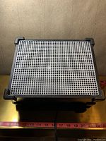 Top view showing silver speaker grill and black textured casing.