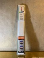 Front of packaged wire cover showing it is a flat screen TV cord cover kit with images illustrating cord hiding and organizing.
