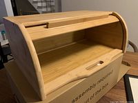 Wood breadbox showing interior and exterior with box below, light wood color
