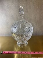 Crystal candy dish with lid on, showing full height and ornate etching on bowl and lid.