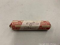 Paper-wrapped roll of 50 pennies, labeled '42', in unopened condition.