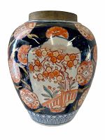 Full front view of antique ginger jar showing floral hand painted design with orange fruit clusters and blue background with white panels.