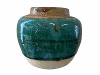 Turquoise glazed antique ginger jar showing rounded body and natural ceramic base.