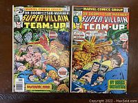 Photo showing both comic book covers of Super Villain Team-Up issues 5 and 6 with some edge and corner wear visible.