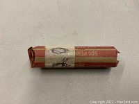Photo shows one unopened roll of 1920 unsearched wheat cent pennies in brown and red paper wrapper.