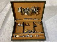 Overview of vintage men's tie clips, cufflinks, and accessories inside original box