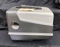 Side view of the gray Revere 505 slide projector case with logo and model number visible.