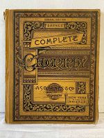 Front cover of Barnes Complete Geography General Edition book showing ornate design and some wear on edges and spine.
