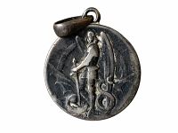 Front view of the antique St. Michael medal showing the figure standing on a dragon with wings extended and sword.