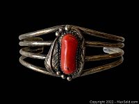 Front view of the silver Native American cuff bracelet showing red stone and silver leaf and bead accents.