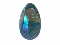 Front view of the iridescent glass egg showing blue hues and internal abstract patterns.