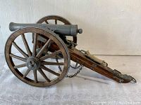 Side view of the Dahlgren 1861 cannon replica showing the metal barrel and wooden carriage with spoked wheels.