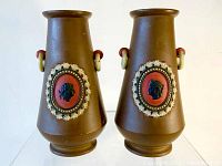 Pair of brown Wilhelm Schiller & Sons Neo-classic vases showing front with orange cameo medallions and decorative handles.