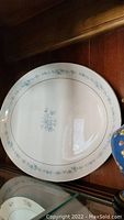 Blue floral pattern large oval serving plate with thin blue border lines on cream background. Likely Johnson Bros. Henley serving plate.