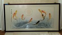Full view of large framed koi fish painting, showing seven koi fish swimming in stylized water with calligraphy along left side.