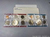 Two 1978 uncirculated US Mint coin sets in original sealed plastic packaging, one blue-bordered and one red-bordered, with a U.S. Mint 1978 Uncirculated Coin envelope.