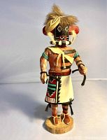 Front view of the Hopi Left Hand Kachina doll highlighting detailed paintwork, feathers, and garment patterns