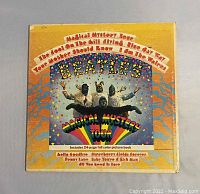 Front cover of the 1967 Beatles Magical Mystery Tour album showing psychedelic artwork and text.