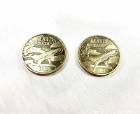 Two Maui Trade $2 coins showing whale design with text Maui Lanai and Maui Nokaoi on one side, dated 2012