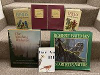Photo showing front covers of a collection of nature books about birds, trees, and wilderness including two Audubon Nature Program volumes.