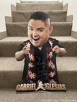 Front view of the signed cardboard standup showing the full figure and signature.