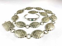 Photo of the belt and bracelet laid flat showing the full length and linking details of the belt alongside the cuff bracelet with turquoise.