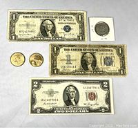 Front view of bills and coins showing type of notes and coins