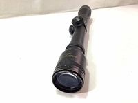 Front angled view of the black Excalibur Max Zone scope showing the clear objective lens and barrel.