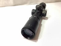 Close-up of front end of Excalibur Tact Zone crossbow scope showing lens and zoom adjustment