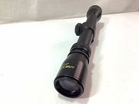 Photo showing Excalibur Vari-Zone crossbow scope from an angled front view highlighting the blue trim near objective lens and scope body details.