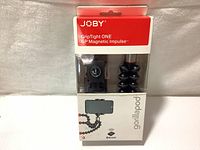 Front view of sealed retail packaging showing Joby GripTight ONE GP Magnetic Impulse Gorillapod tripod and Bluetooth remote shutter in clear window section.