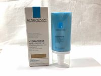 Front view of the unopened white box with blue accent and the matching light blue product tube with white pump dispenser beside it.